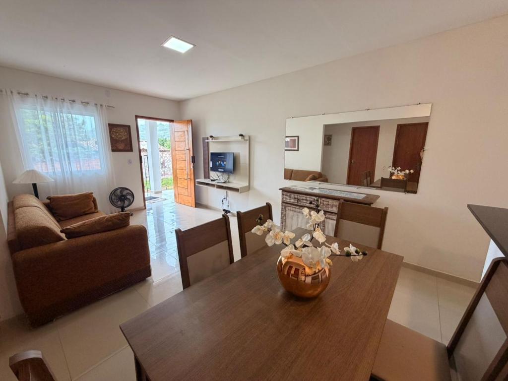 a living room with a table and a couch at Casa Villa Serrano in Lençóis