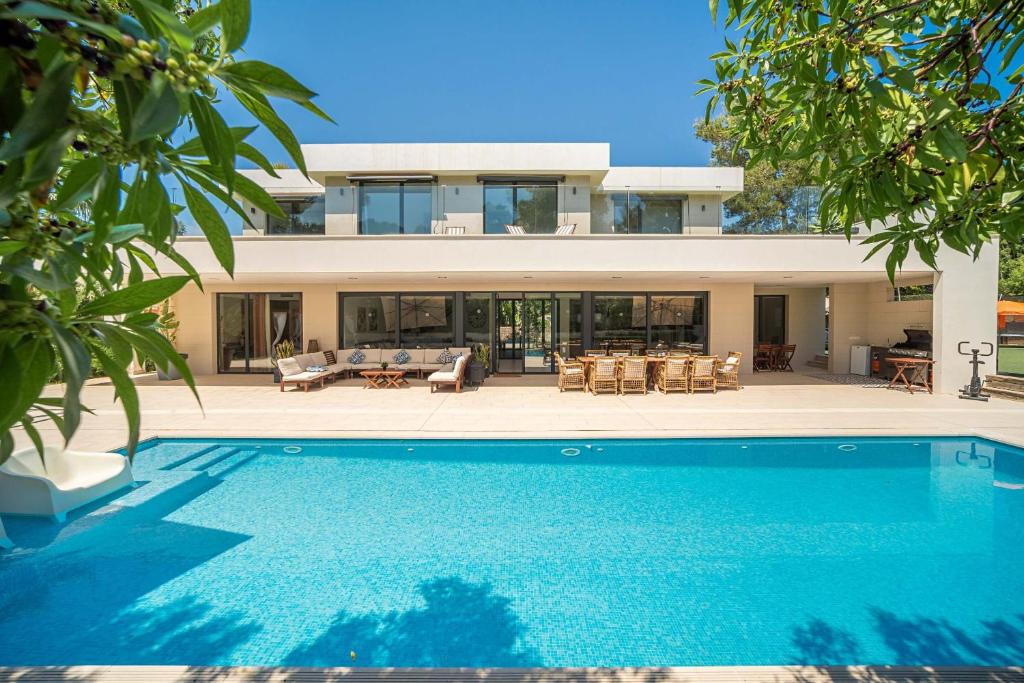 a house with a swimming pool in front of a house at Villa SP1 Suites Santa Ponsa by Sealand Villas in Santa Ponsa