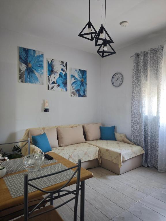 a living room with a couch and a table at Elina House 2 in Nikiti