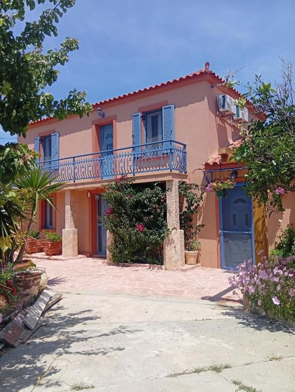 a house with a balcony and a driveway at Maronia in LivadhokhÃ³rion