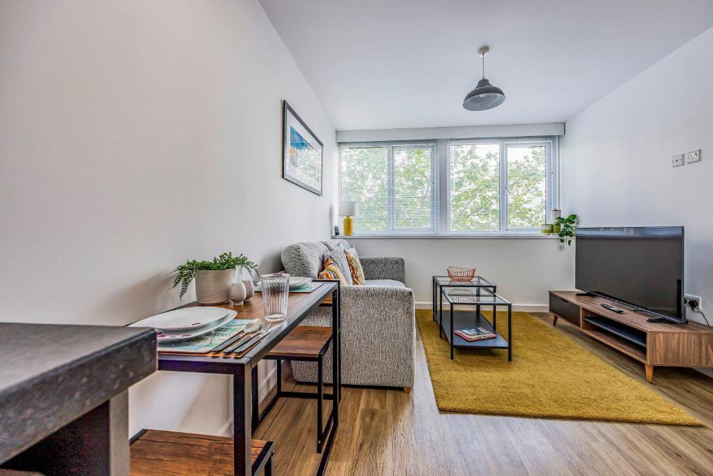 a living room with a couch and a tv at Stylish Flat in the City Centre - Pass the Keys in Portsmouth