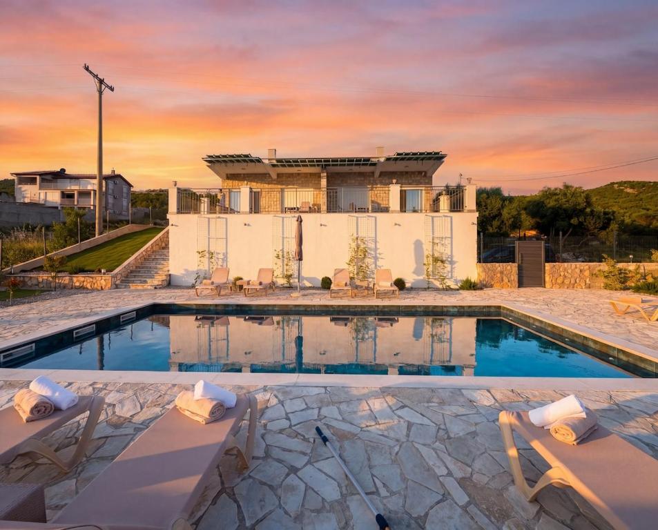 a villa with a swimming pool and a house at Villa Aurea Luxury Sunset with Pool in Krimovice