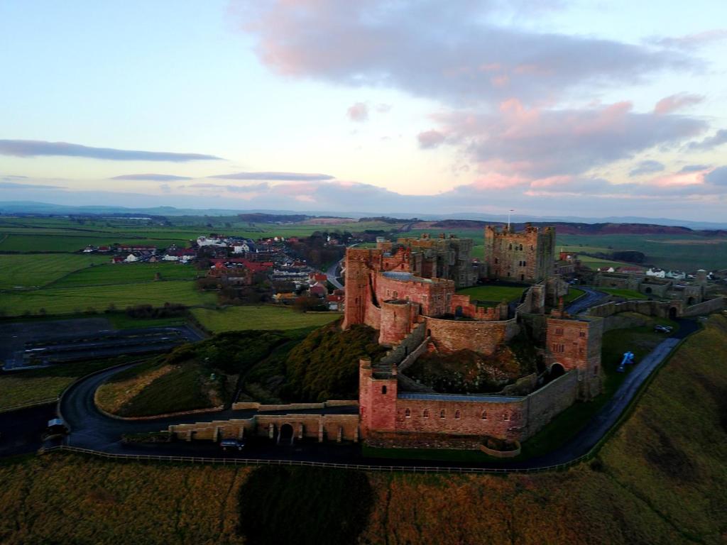 an aerial view of an old castle on a hill at Pintail Apartment Bamburgh in Bamburgh