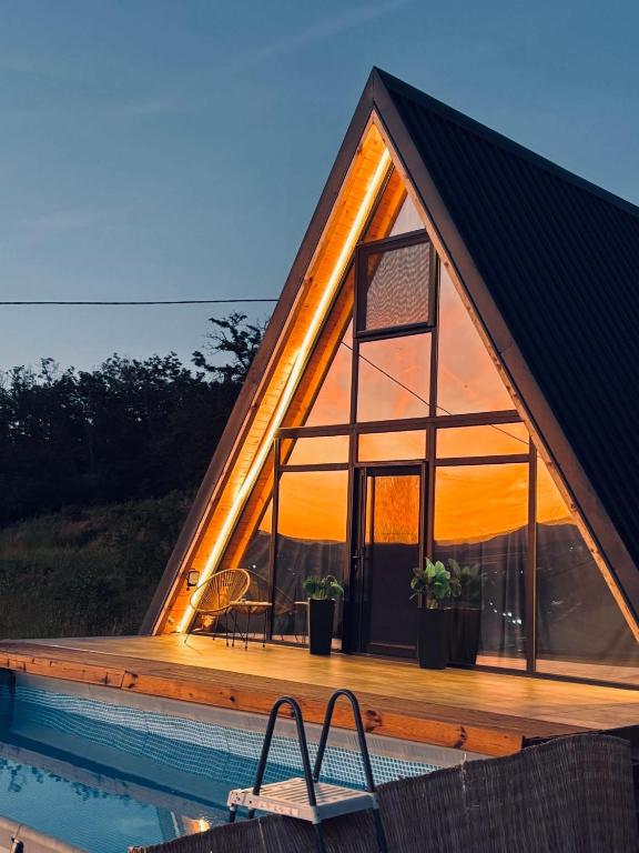 a frame house with a pool and a deck at Vila Ahouse in Jagodina