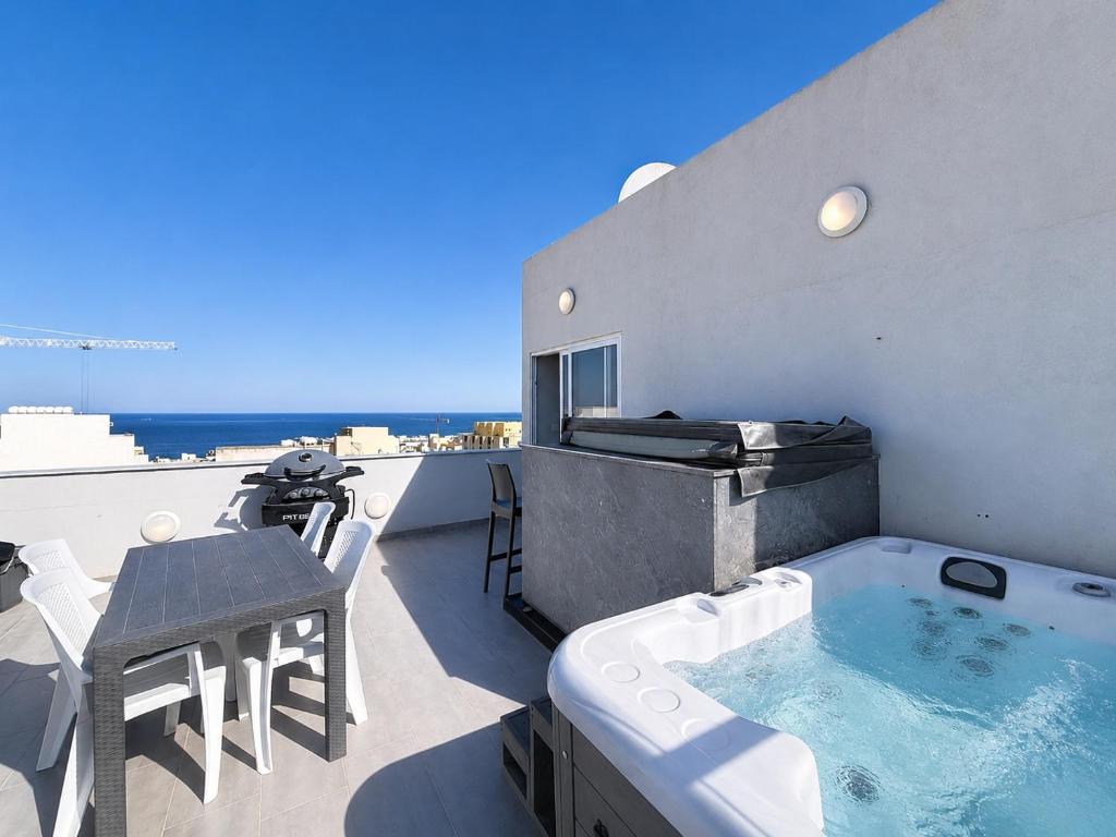 a hot tub on the roof of a house at Prestigious & Modern SeaView Penthouse with Private Jacuzzi in Marsaskala