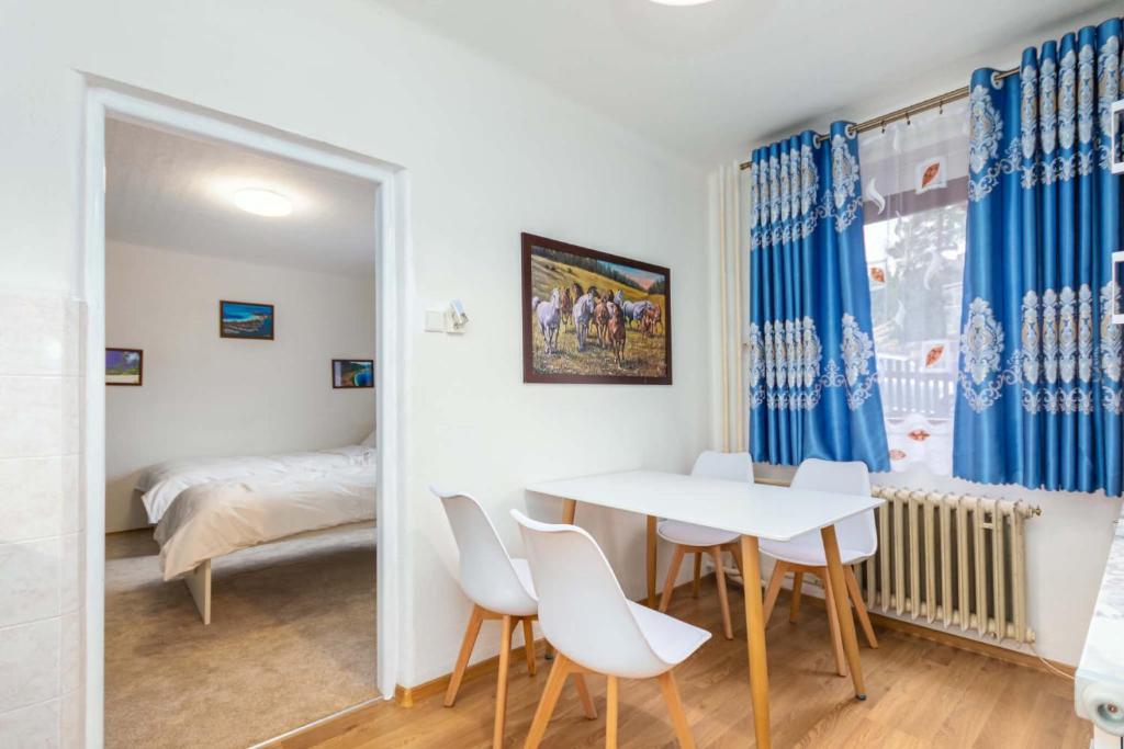 a room with a table and chairs and a bedroom at Byty Na vyhlídce in Zdice