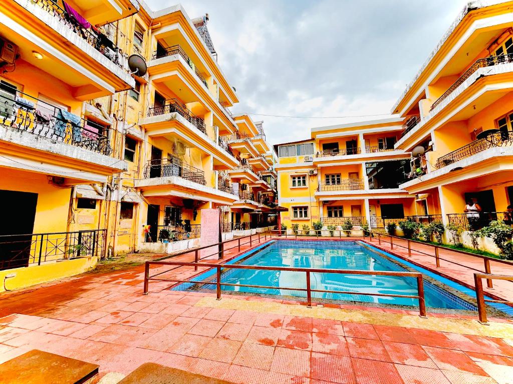 a swimming pool in the middle of a building at Baga Central Studio Apartment in Baga