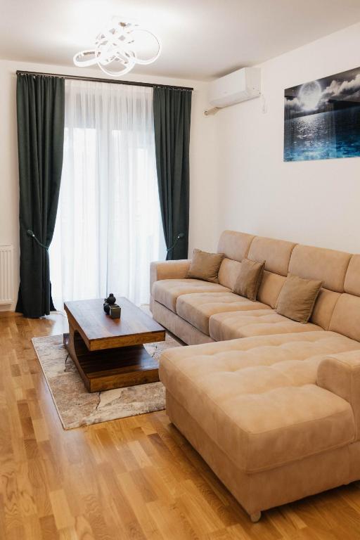 a living room with a couch and a coffee table at Numero Uno LUX in Sombor