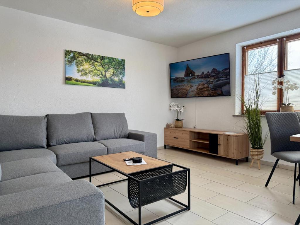 a living room with a couch and a table at Gästehaus in Bad Sülze