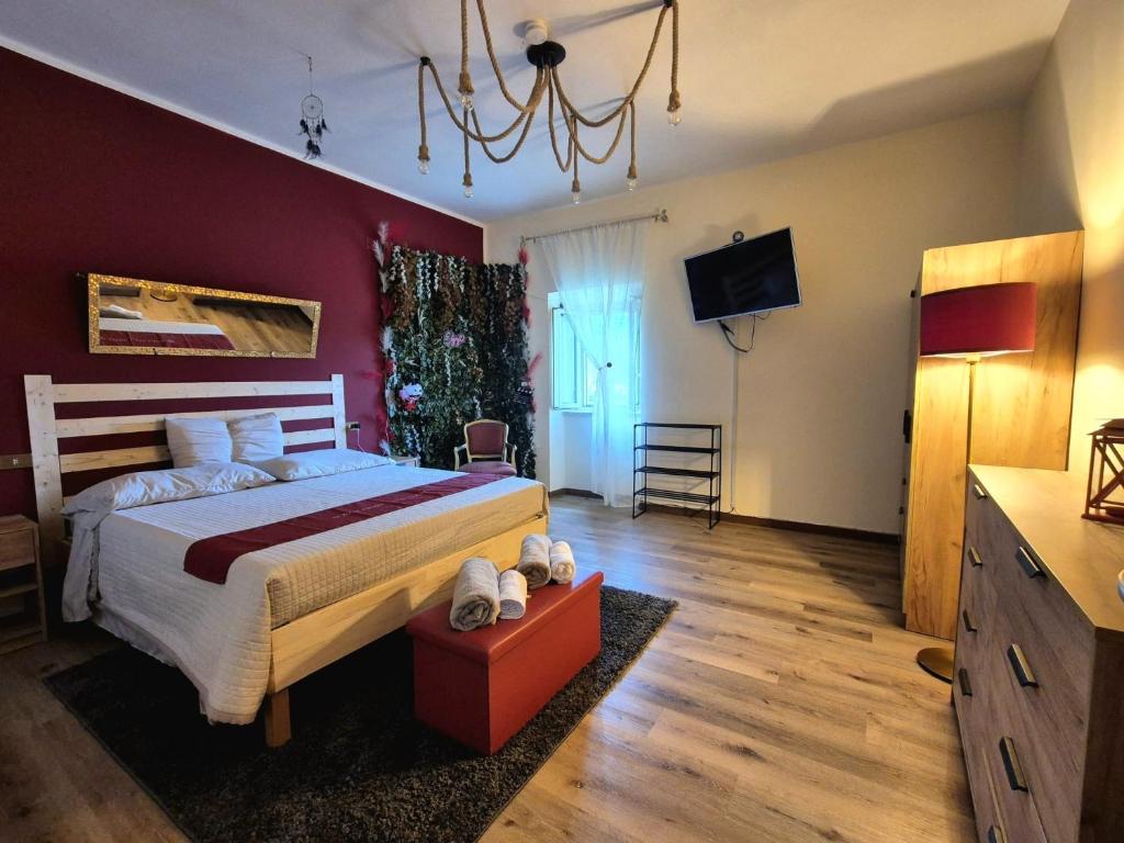 a bedroom with a large bed and a tv at Sogni appesi in Valleluce-Cese
