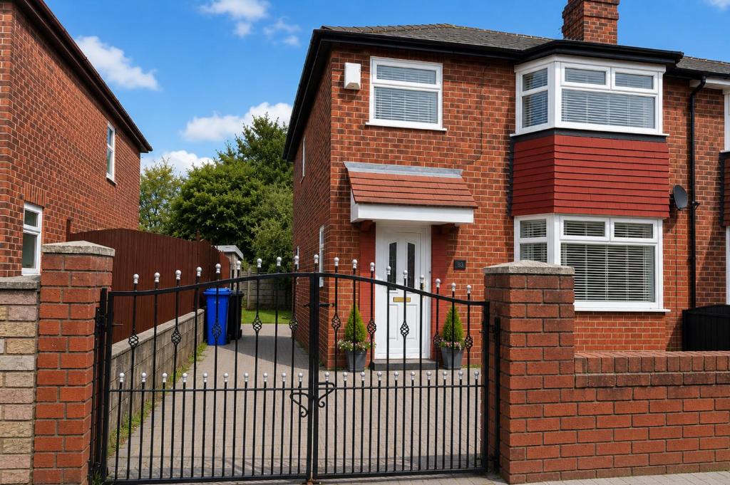 a brick house with a wrought iron gate at Amy's place in Warrington