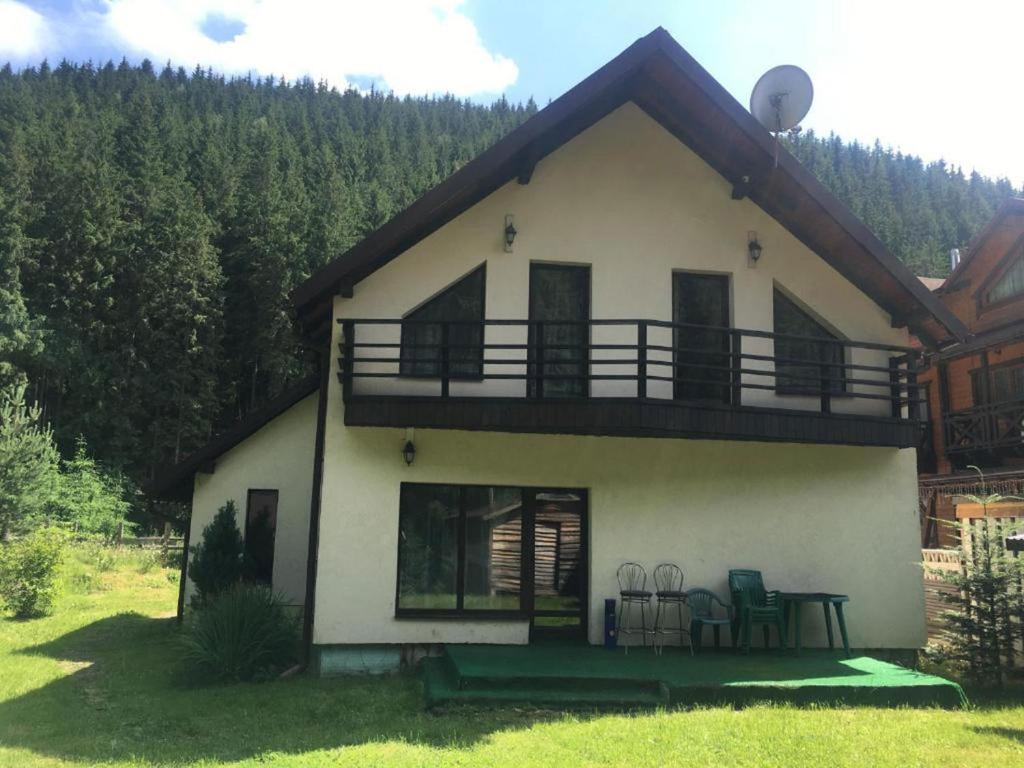 a house with a balcony on the side of it at Guest house Alyaska in Bukovel
