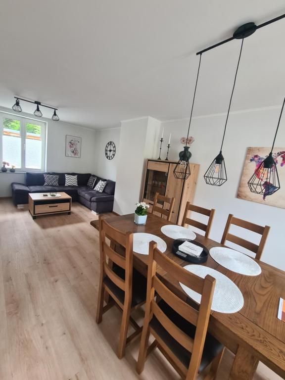 a dining room and living room with a table and chairs at Ferienhaus Birute in Bernkastel-Kues