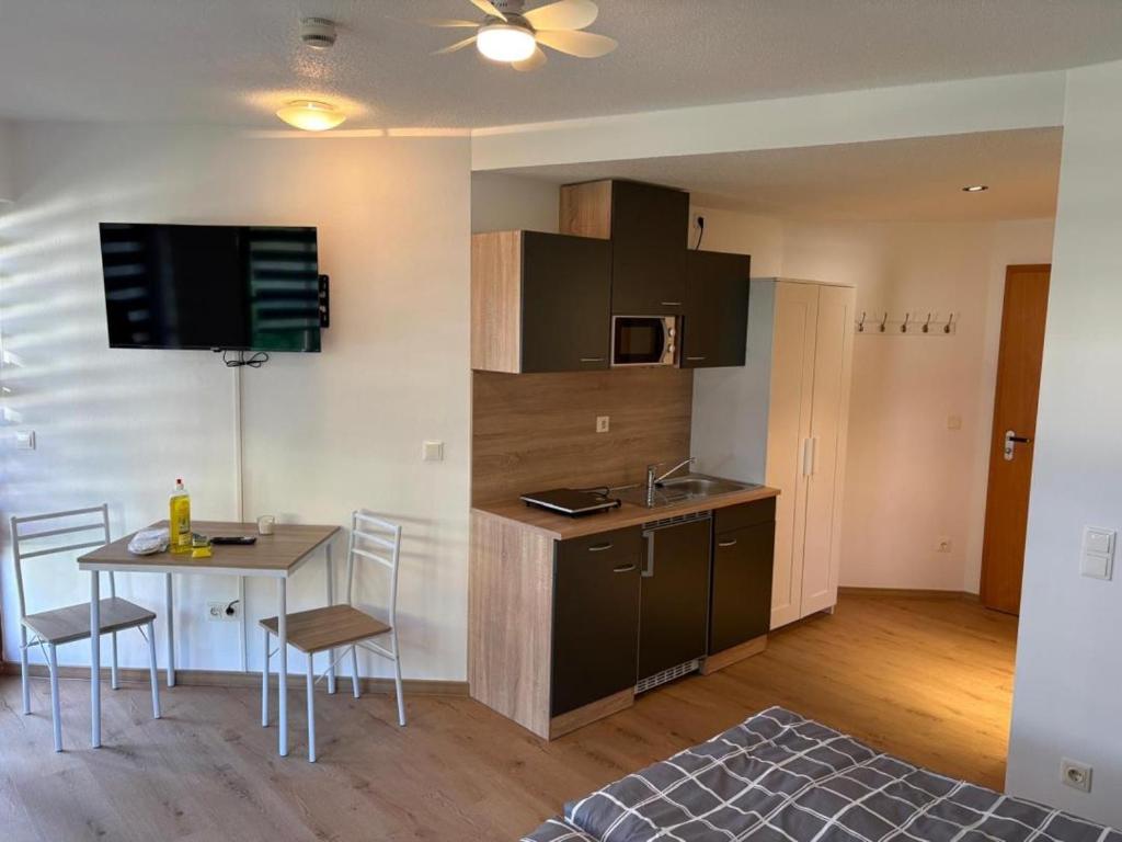 a kitchen with a table and a small kitchen with a dining room at NEU! Ferienappartement Nino in Rötz