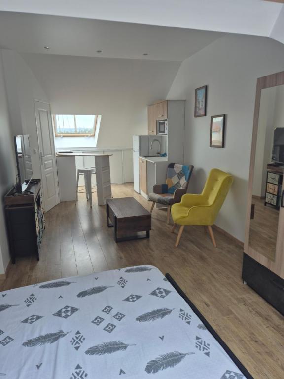 a living room with a bed and a dining room at STUDIO COZY 20m2 in Les Attaques