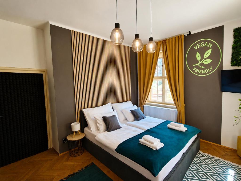 a bedroom with a bed with two towels on it at Vila Mezi Časy in Trutnov