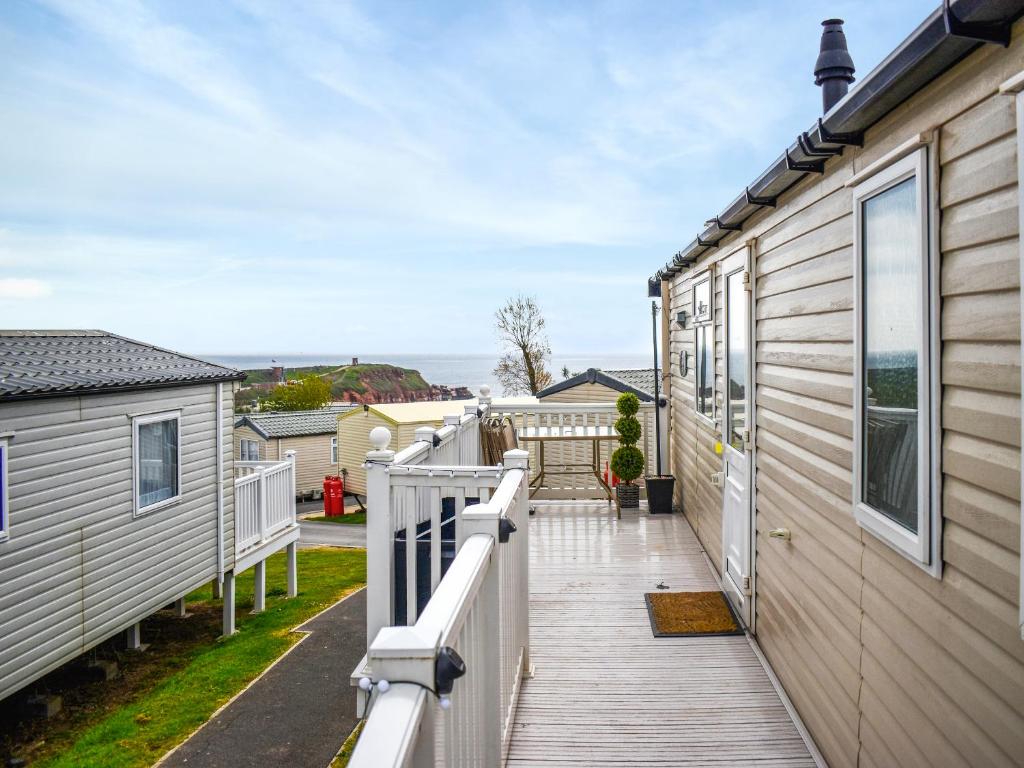 a wooden deck next to a house at Elms 116 - Ukc9403 in Exmouth