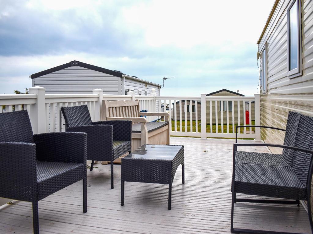 a patio with chairs and a table on a deck at Beech Walk 45 - Ukc9406 in Exmouth