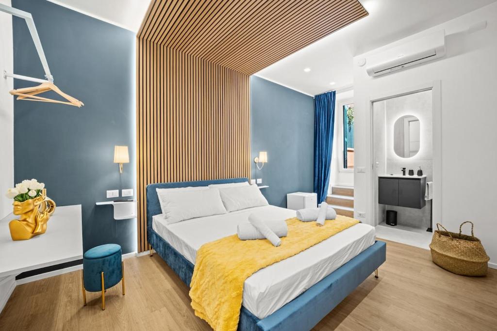 a bedroom with a large bed with blue walls at Hidden Pyramid Suites in Rome