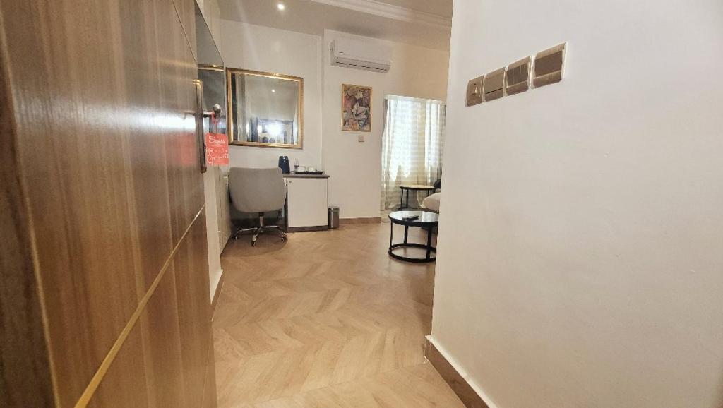 a hallway with a room with a table and a chair at CARITAS HOTEL AND suite in Araromi