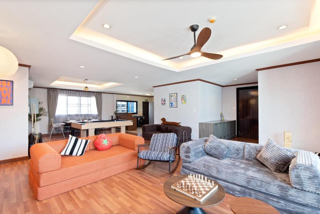 a living room with a couch and a table at Capitel Ekkamai Hotel in Sathani Khlong Tan