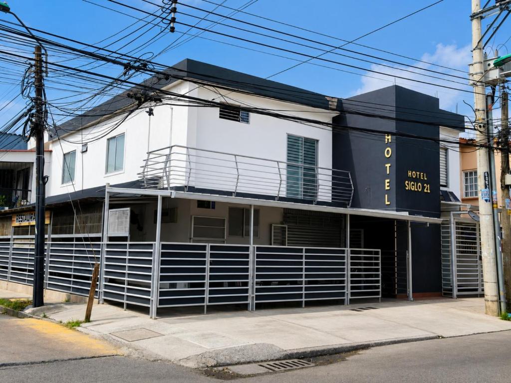 a white building with a scoreboard on the side of it at Hotel Siglo 21 in Cali