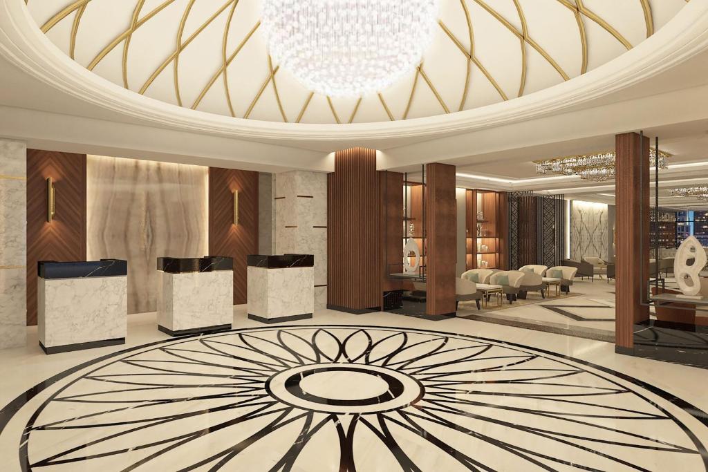 a large lobby with a chandelier and a large rug at Sheraton Bishkek in Bishkek
