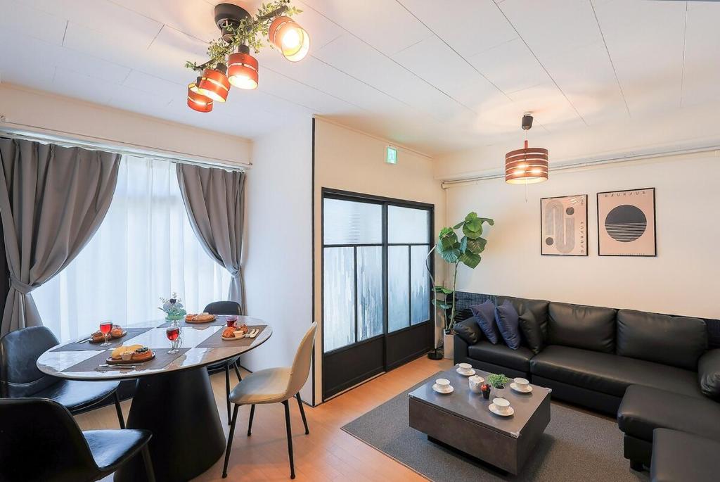 a living room with a couch and a table at 宿丸一 in Tajimi