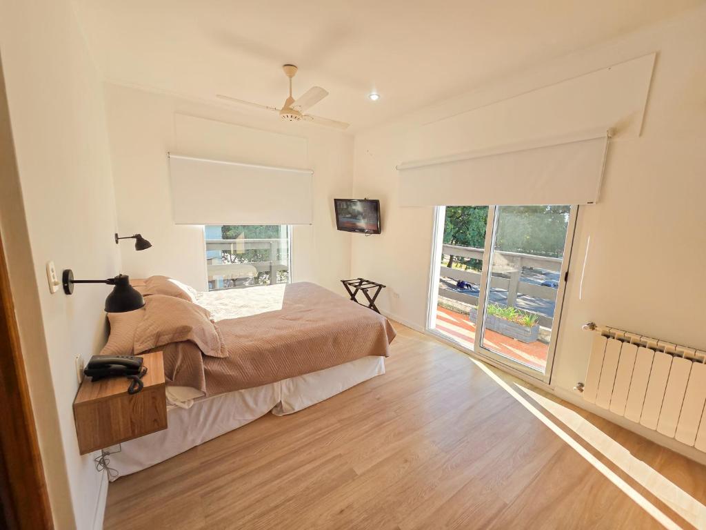 a bedroom with a bed and a large window at Hotel Milton in La Paz