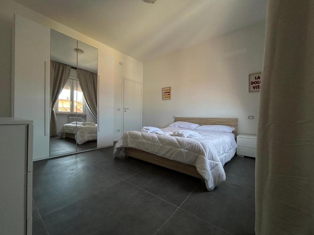 a bedroom with a bed and a large mirror at Residence Greta in Parma