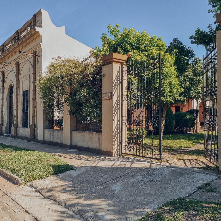 a gate in front of a building at Nido de Pajaros Posada Boutique in Concepción