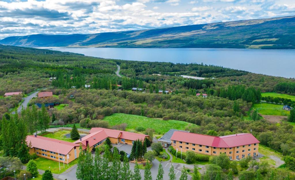 an aerial view of a building with a lake at Hotel Hallormsstadur in Egilsstaðir