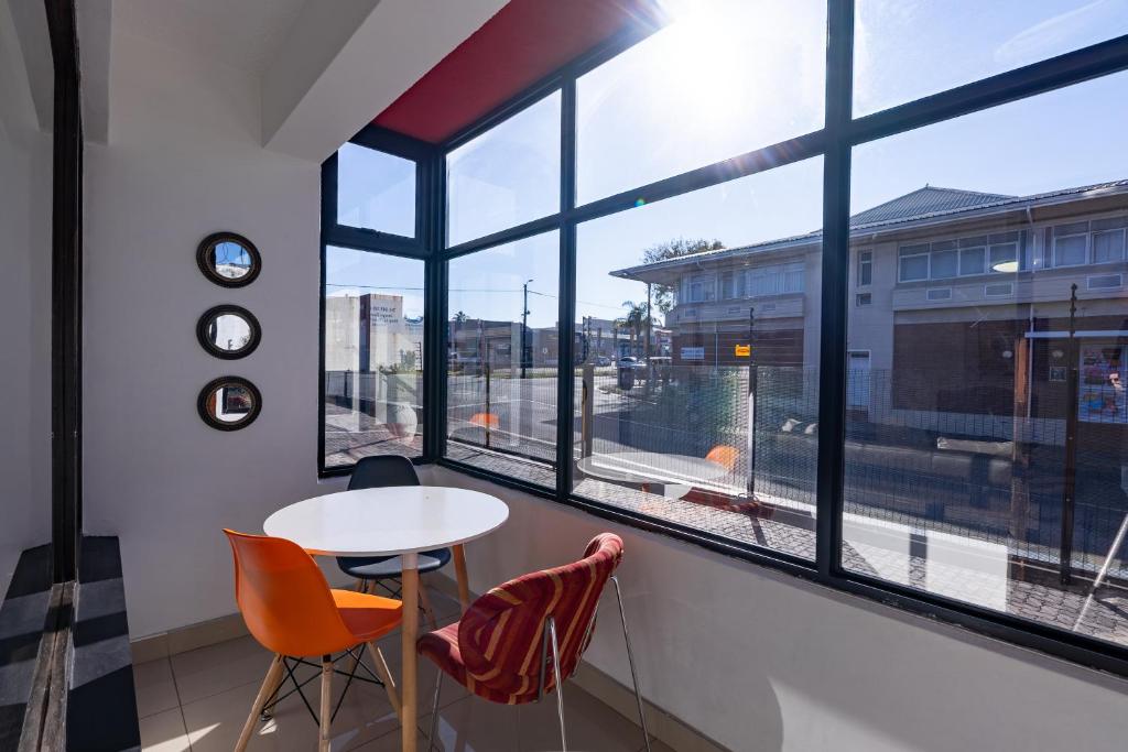 a room with a table and two chairs and a window at Safi Self-Catering Suite 1 in Bunkers Hill
