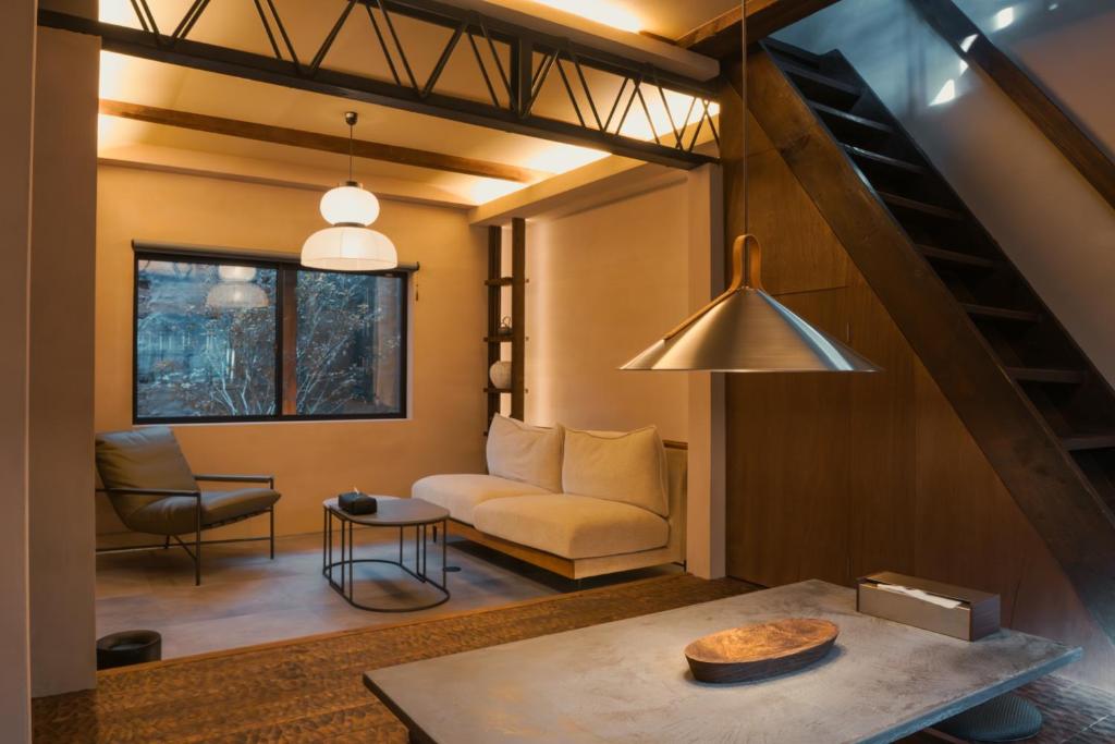 a living room with a couch and a table at 燈やー弐 in Kyoto