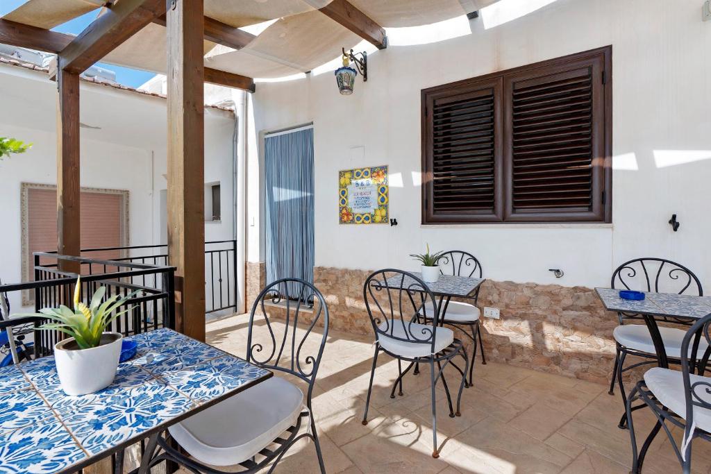a patio with tables and chairs on a balcony at Bnb La Rocca San Vito Lo Capo in San Vito lo Capo