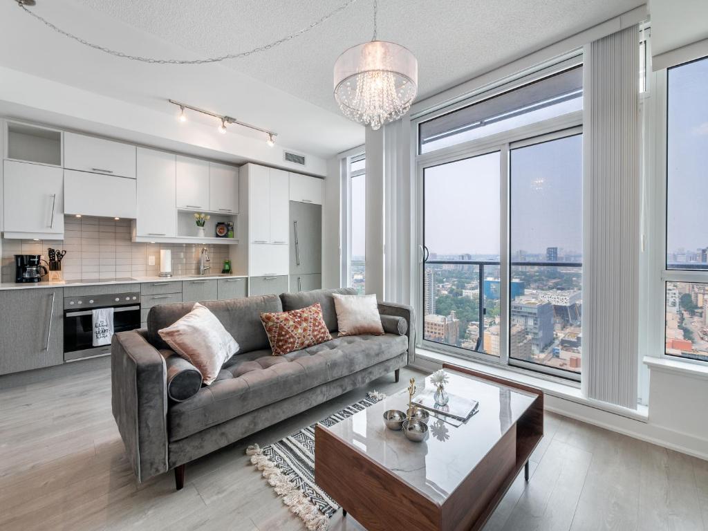 a living room with a couch and a table at Atlantis Suites The Entertainment District - Toronto in Toronto