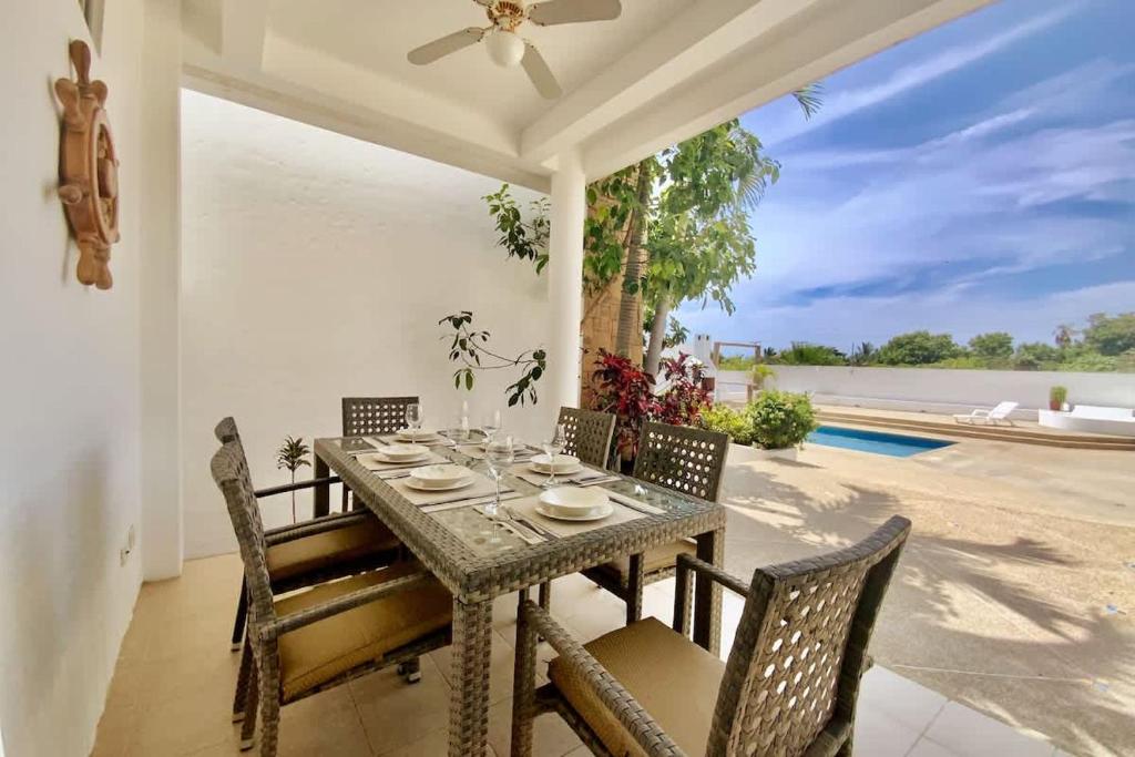 a dining room with a table and chairs at Gorgeous Beach house 3BD Pool and BBQ in Punta Blanca