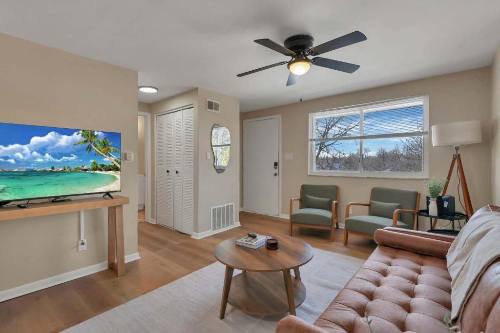 a living room with a couch and a flat screen tv at The Neff Nest - 1 BR Flat in Columbus