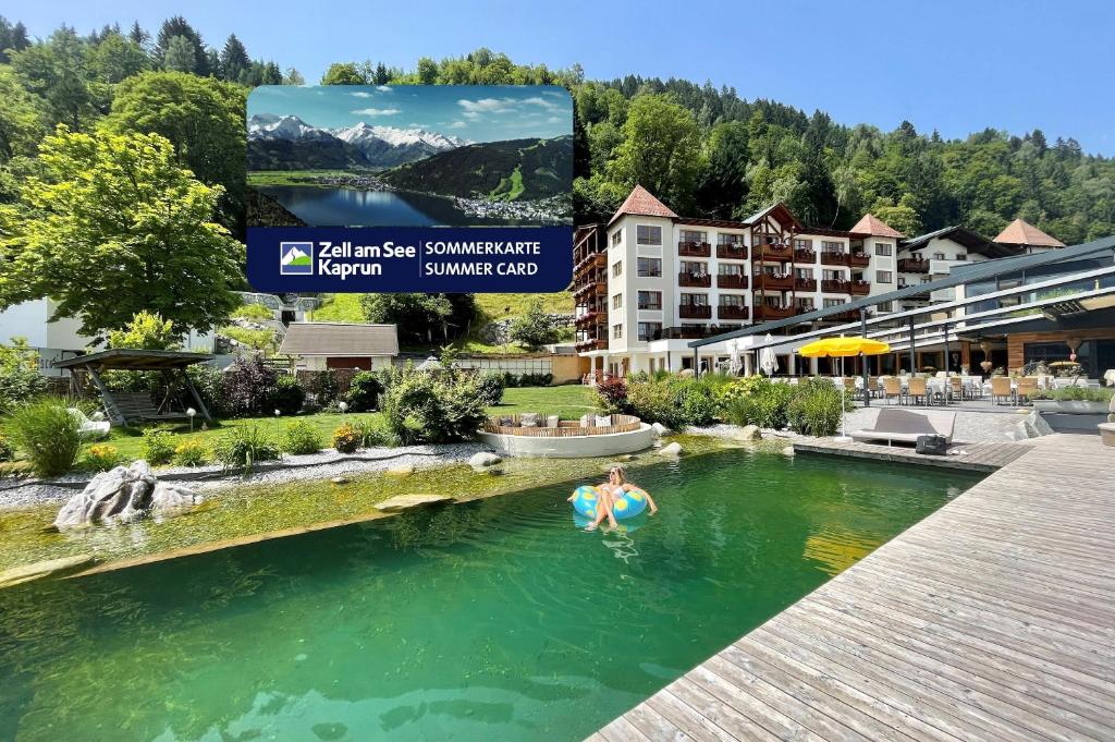a person in a pool at a resort at Superior Sport und Familienresort Alpenblick in Zell am See