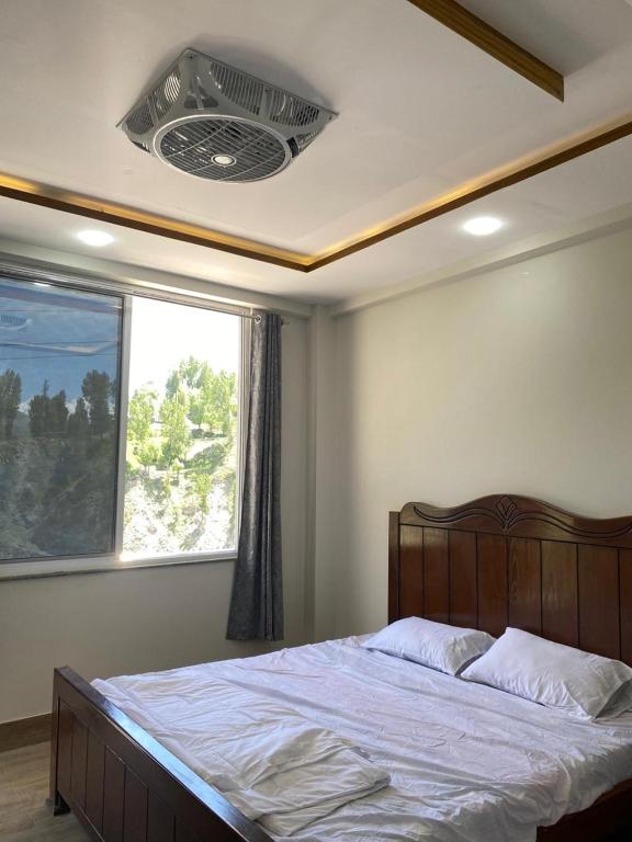 a bedroom with a large bed with a window at Hill View Hotel in Astor