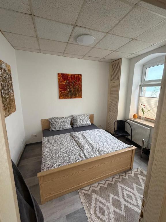 a bedroom with a bed in a room with a window at Pension Zur Taube in Bautzen