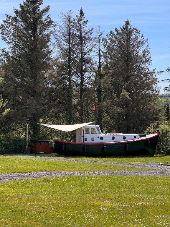 a boat sitting on the grass in a field at The Ship Aground Woolacombe in Woolacombe