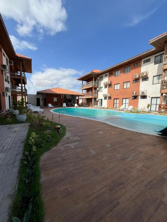 a swimming pool in the middle of a building at Vila Atlântida BEACH FLAT 311B in Luis Correia