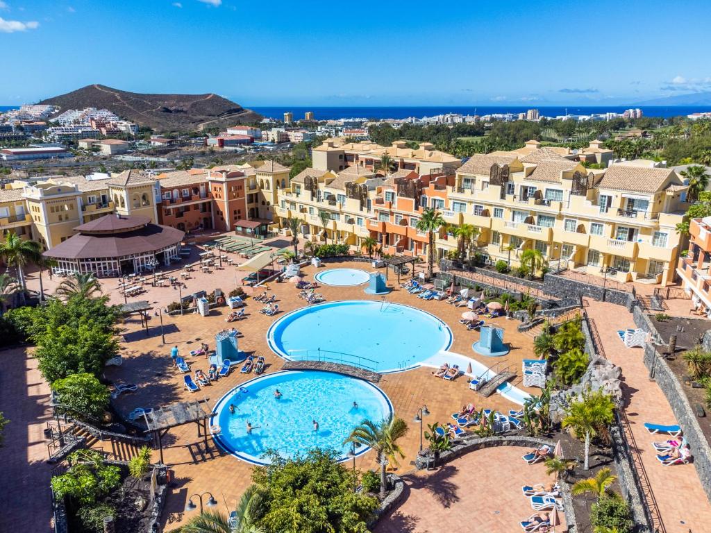 an aerial view of a resort with two pools at OBSIDIAN Granada Park in Arona