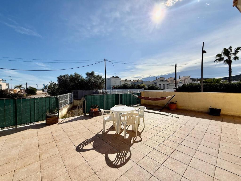 a white table and chairs on a patio at Los Olivos - Casa Adosada in Peniscola