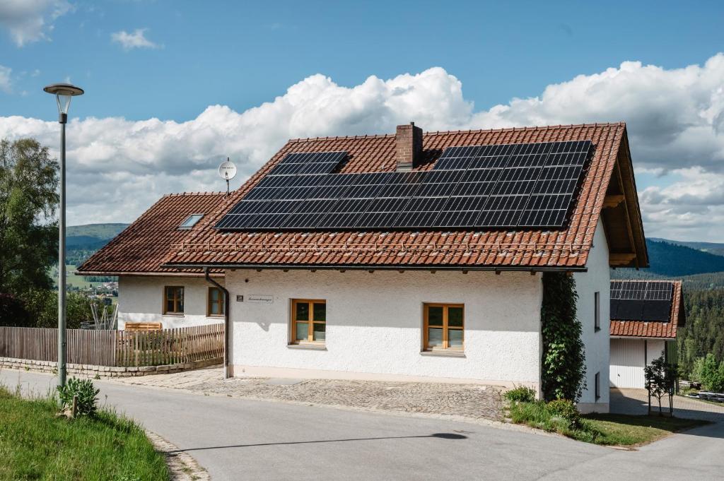 a house with solar panels on the roof at Ferienwohnungen Lusenblick in Freyung