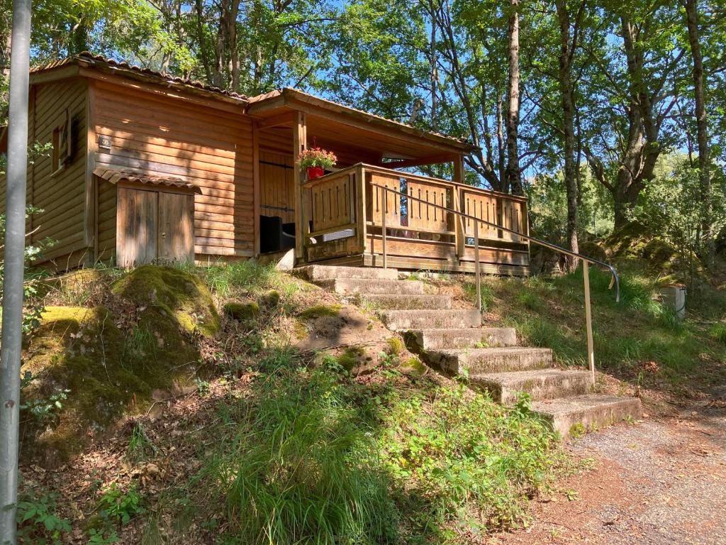 a log cabin with stairs leading to a porch at SAS Le Bataillet in Montégut