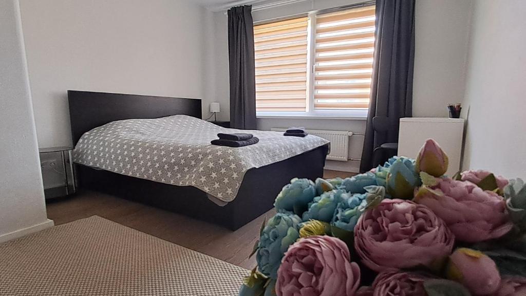 a bedroom with a bed and a room with a couch at Dzīvoklis Baldone, Latvija in Baldone