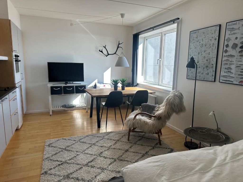 a living room with a table and a dining room at Aurora Studio Apartments in Nuuk