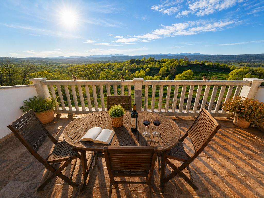 a table and chairs on a deck with a view at El Triskel de Chumbea- Confort y naturaleza en la Sierra de Béjar in Navalmoral de Béjar